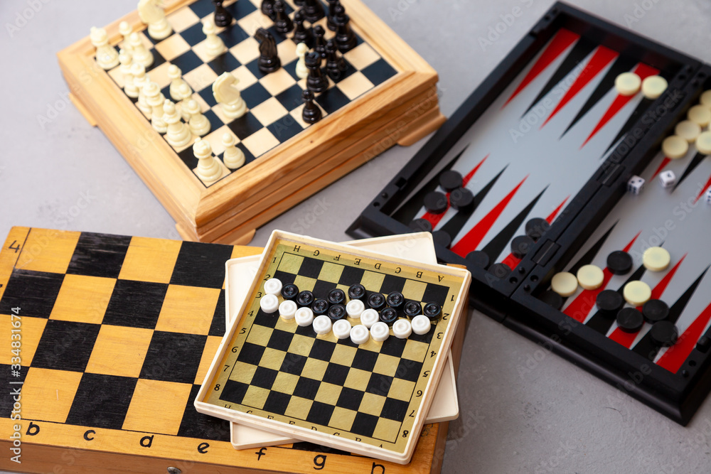 Board games on the table. Chess, backgammon, checkers. Boards are laid out for the game. Play, have fun at home. Leisure, hobbies. Board games on the table. Chess, backgammon, checkers. Boards are laid out for the game. Play, have fun at home. Leisure, hobbies.