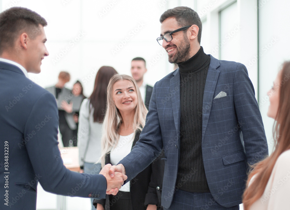 happy business people shaking hands with each other. happy business people shaking hands with each other.