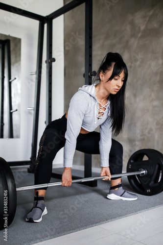 Train Hard Feel Good - Beautiful Fit Woman Doing Barbell Squats In The Gym. Active lifestyle