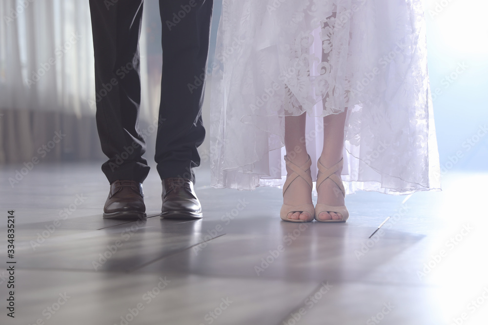 Newlywed couple in festive hall, closeup of legs
