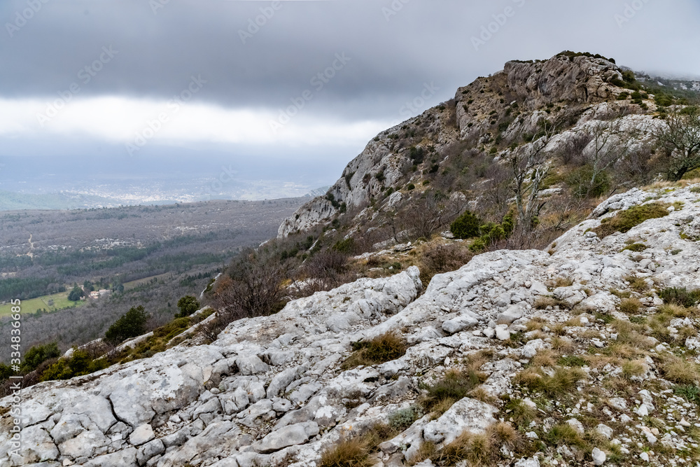 The mountain over grotto of Mary Magdalene at cloudy weather, clouds over a valley, a dry grass The mountain over grotto of Mary Magdalene at cloudy weather, clouds over a valley, a dry grass
