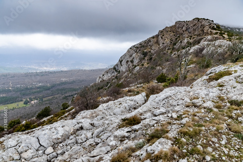 The mountain over grotto of Mary Magdalene at cloudy weather, clouds over a valley, a dry grass photo