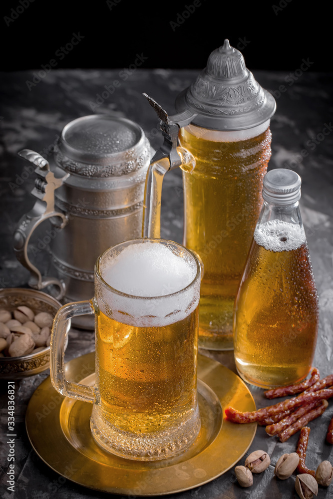 Light beer in a glass, on an old background. Light beer in a glass, on an old background.