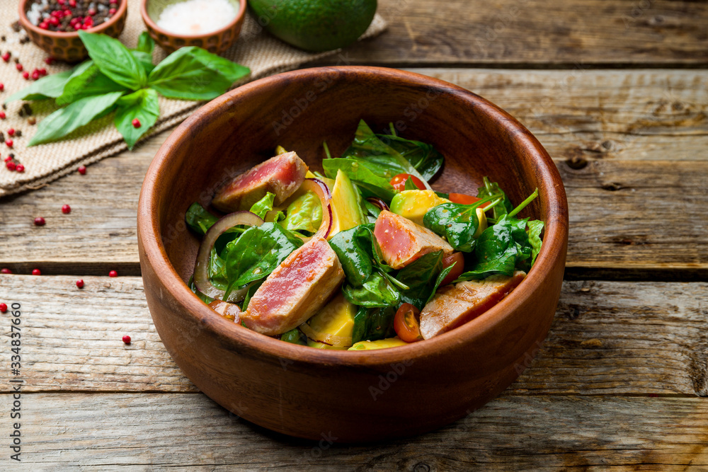 Nicoise with tuna on wooden table Nicoise with tuna on wooden table