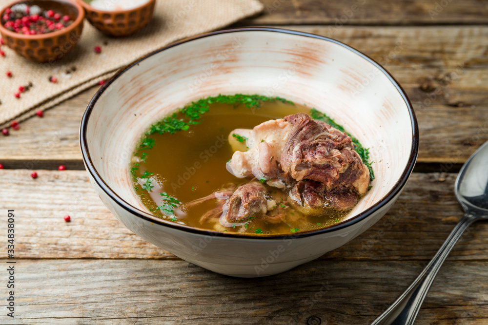soup with veal on wooden table