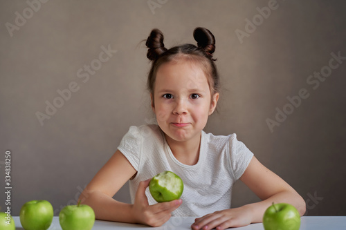 Beautiful funny girl with green apples. Proper nutrition is health.
