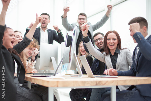 group of happy office employees sitting at a table.