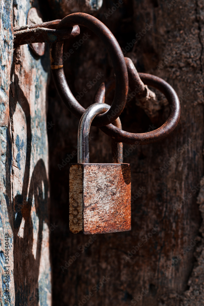 padlock on old wooden door padlock on old wooden door