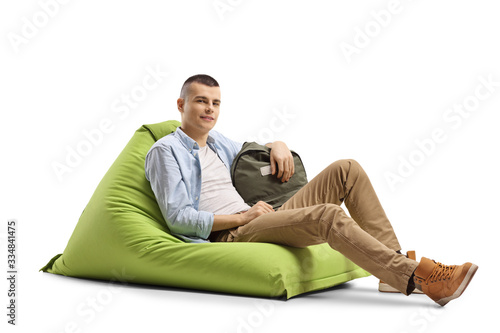 Male student sitting on a green bean bag chair © Ljupco Smokovski