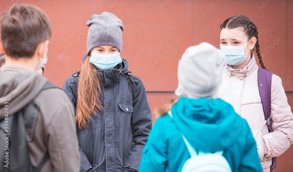 city residents adults and children observe quarantine and go in masks.
