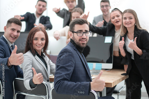 group of young professionals showing thumbs up