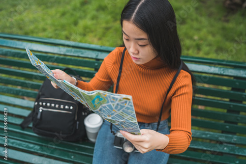 Asian woman looking at a map. photo