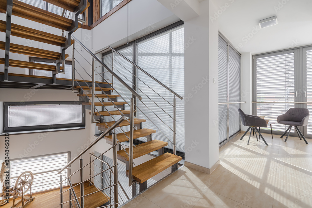 Interior with wooden stairs and large windows Interior with wooden stairs and large windows