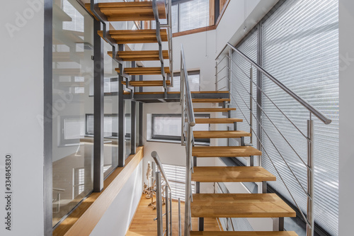 Interior with wooden stairs and large windows