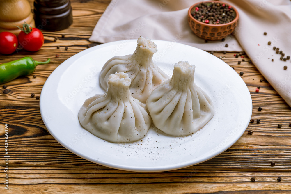 Khinkali with lamb on wooden table Khinkali with lamb on wooden table