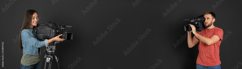Operators with professional video cameras on black background, space for text. Banner design Operators with professional video cameras on black background, space for text. Banner design