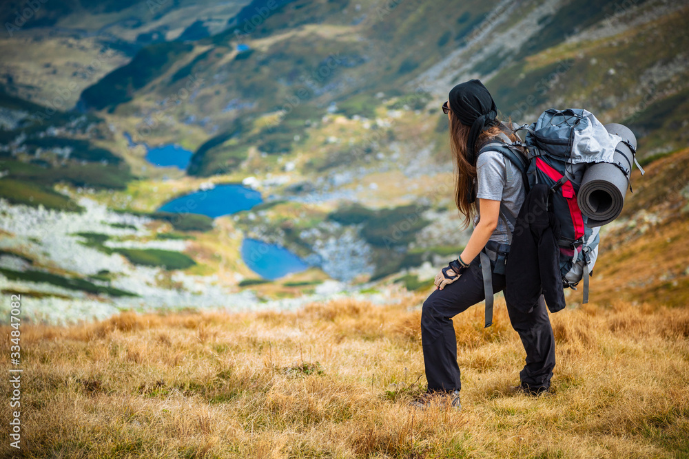 Hiking trough epic mountain landscape with a big backpack, exploring and feeling the freedom of nature Hiking trough epic mountain landscape with a big backpack, exploring and feeling the freedom of nature