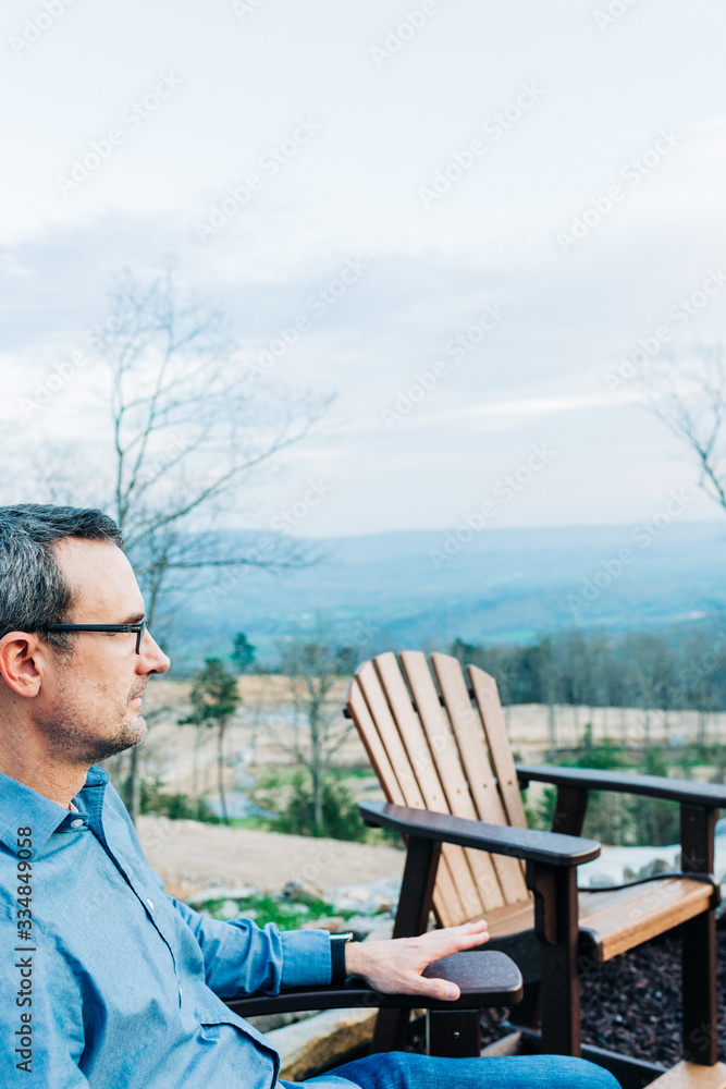Fototapeta premium Man Relaxing By Outdoor Fire Pit