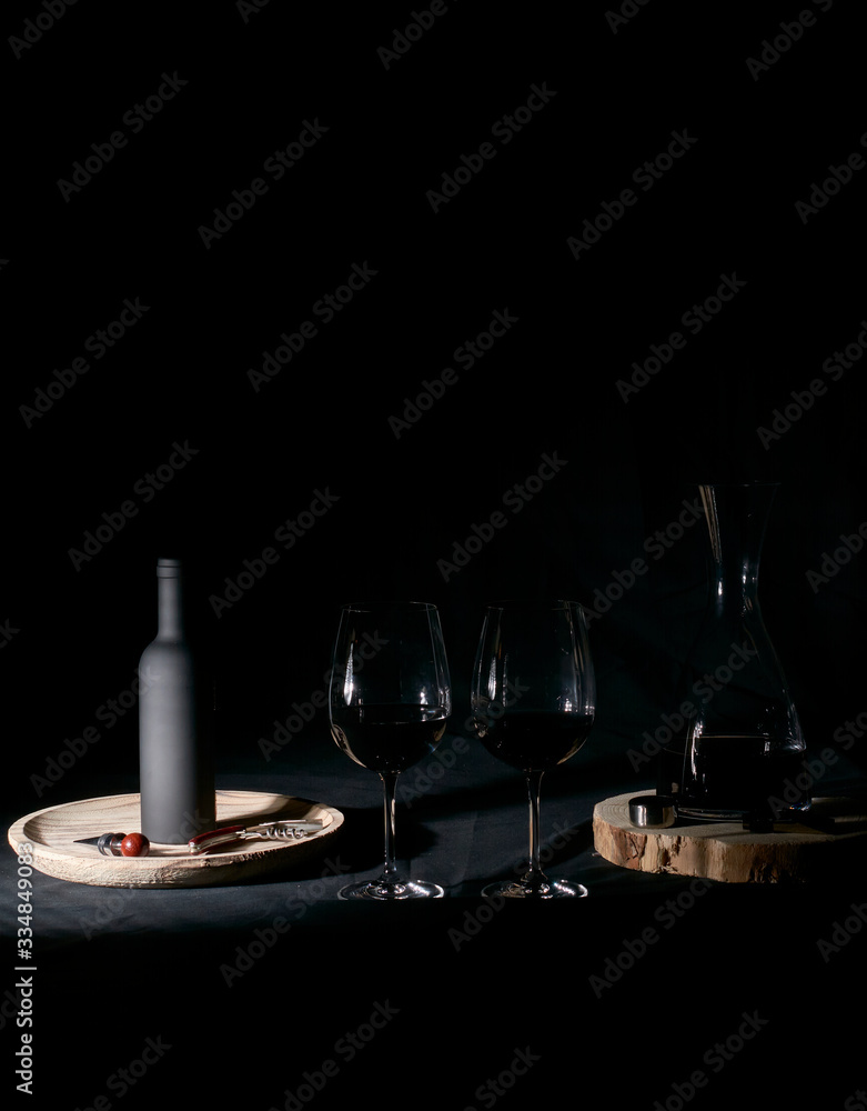 Wine glasses with bottle and pourer.