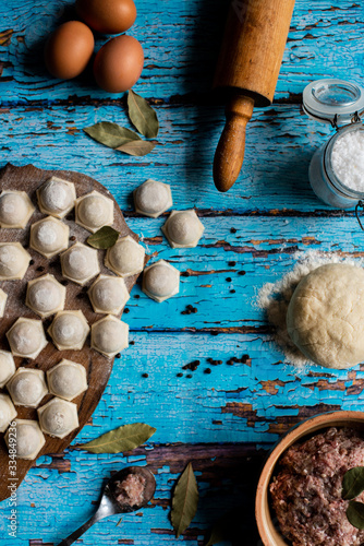 Traditional Russian dish pelmeni.Meat dumplings on wooden rustic background