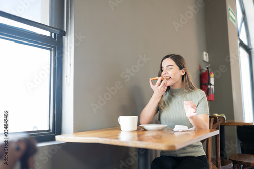 Eating pastries in a bakery shop