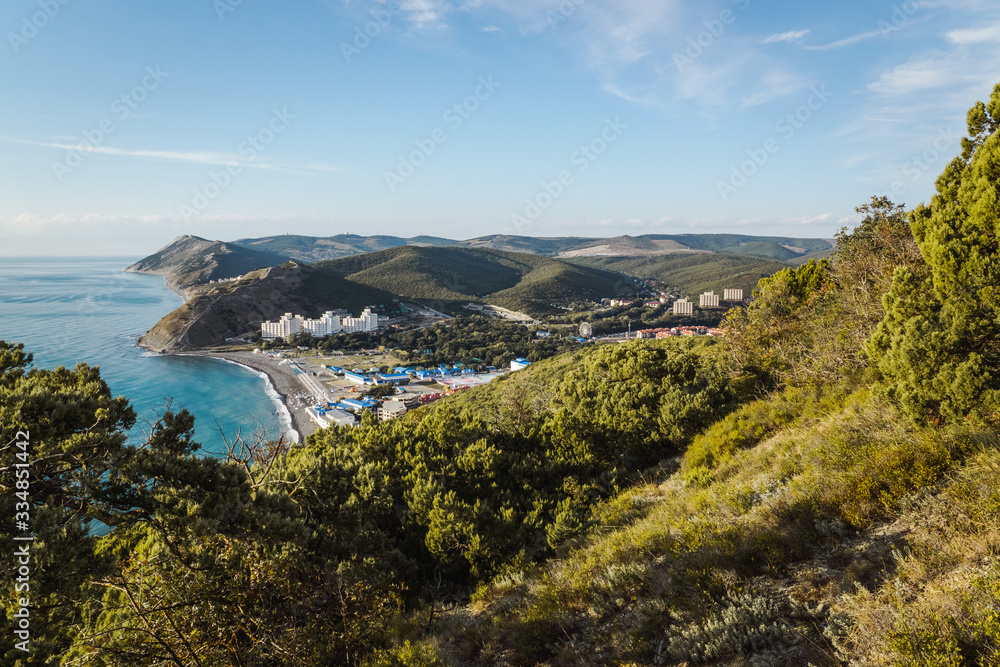 Fototapeta premium View of the resort village of Sukko in Russia from Mount Soldatskaya covered with juniper forest. The beginning of the Caucasus Range. Valley at the Black Sea.