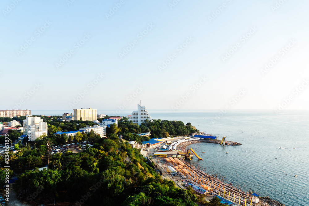 The coast of Anapa from a height. View of the calm Black Sea, the stone beach High Coast, the sanatorium, and the old part of the city. Summer at the resort.