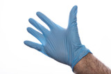 Men's hand in a blue latex glove. Hand protection against viruses.