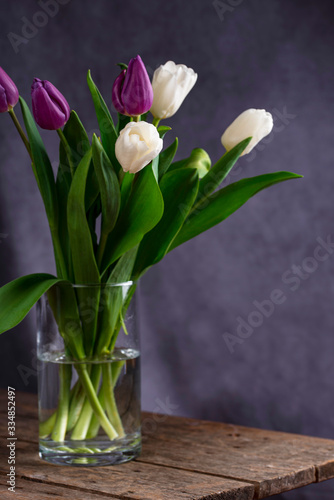 White and purple tulips on vase