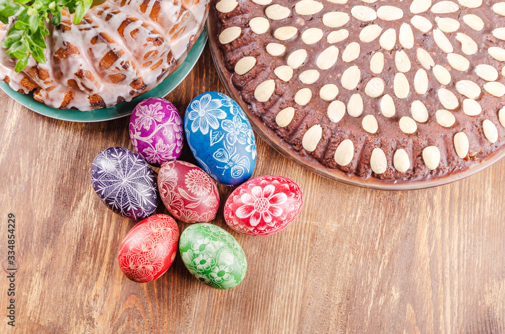 colorful easter eggs, easter cake and tulips on wooden table colorful easter eggs, easter cake and tulips on wooden table