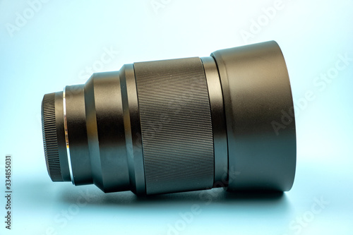 Optical digital camera lens isolated on blue background.