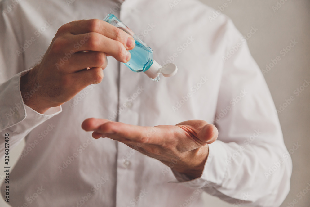 Man in white shirt using hand sanitizer gel dispenser, coronavirus Covid-19 at public places. Antiseptic, Hygiene and healthcare concept Man in white shirt using hand sanitizer gel dispenser, coronavirus Covid-19 at public places. Antiseptic, Hygiene and healthcare concept