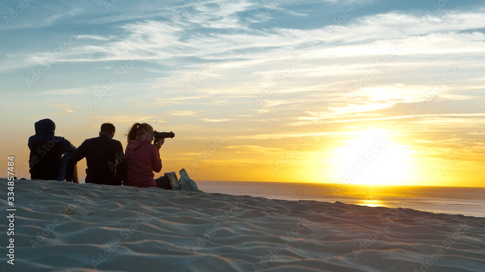 Fototapeta premium Sunset at sea, people have a rest 
