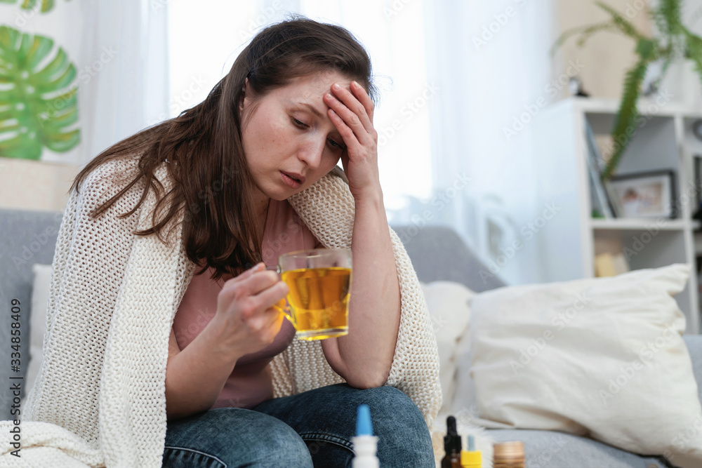 Ill woman drinking hot medicine, soluble powder in a glass of water Ill woman drinking hot medicine, soluble powder in a glass of water