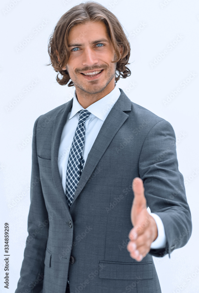 Smiling friendly businessman offers a handshake Smiling friendly businessman offers a handshake