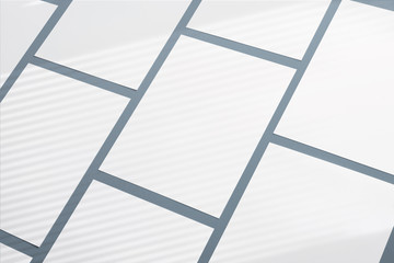 Blank paper poster flyers letterhead on grey background with soft shadows and geometric light overlay as template for design presentation, promotion, portfolios etc.