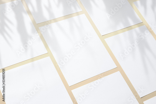 Blank paper poster flyers letterhead on orange background with soft shadows and floral light overlay as template for design presentation, promotion, portfolios etc.