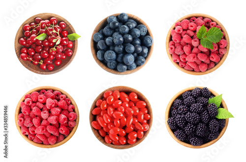 Set of bowls with different fresh berries on white background, top view
