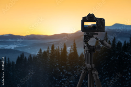 Recording beautiful view of mountain landscape on professional video camera