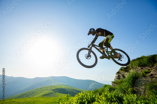 Professional rider is jumping on the bicycle.