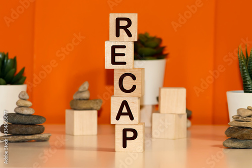 Recap word from wooden blocks on desk photo