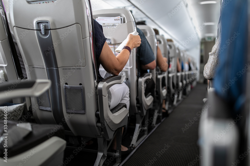 Fototapeta premium Interior of commercial airplane with passengers in their seats during flight.