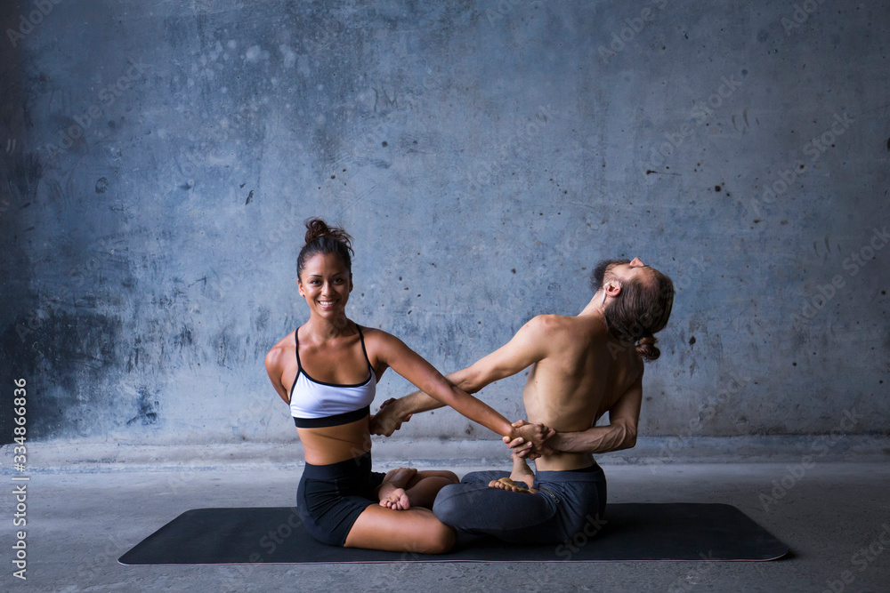 Latin couple practice acroyoga together. Concept of trust and support. Latin couple practice acroyoga together. Concept of trust and support.
