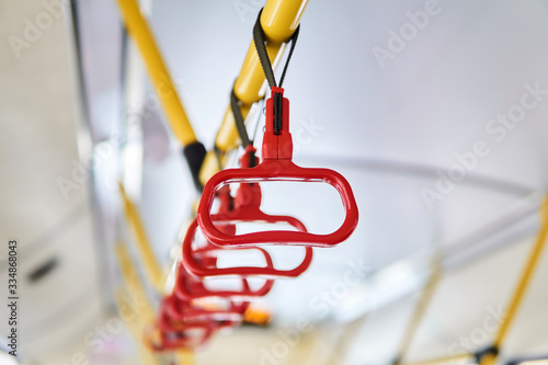 interior elements of public transport - city bus grab handles - on a blurred background