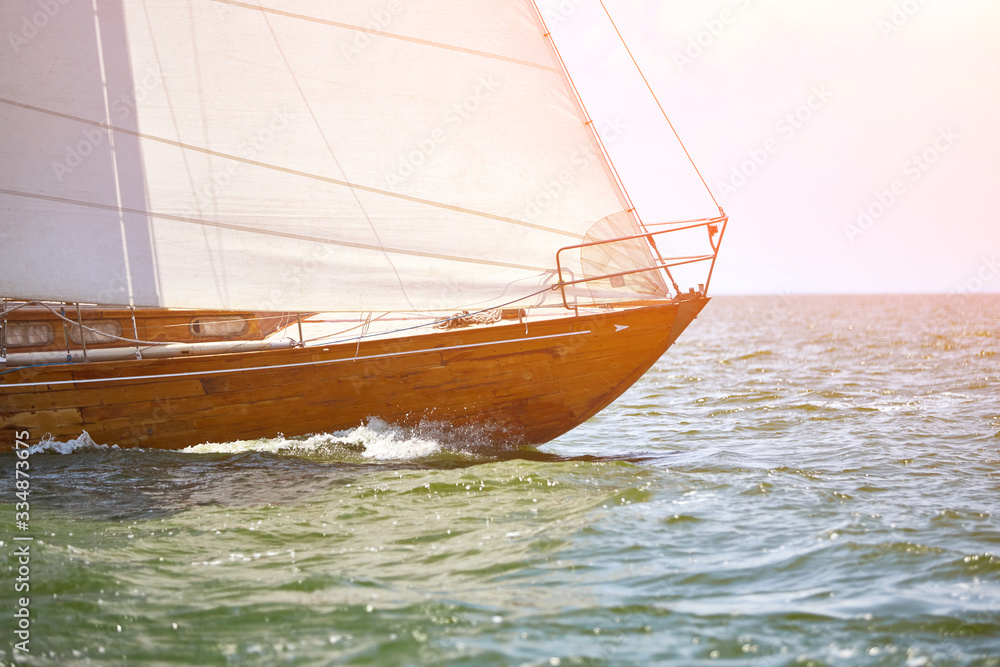Obraz premium Wooden sailing yacht is sail in the waves during race.