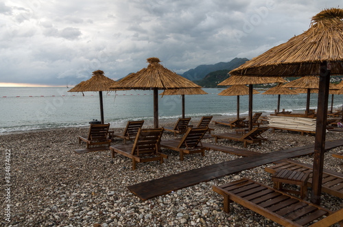 umbrellas on an empty beach  stormy weather