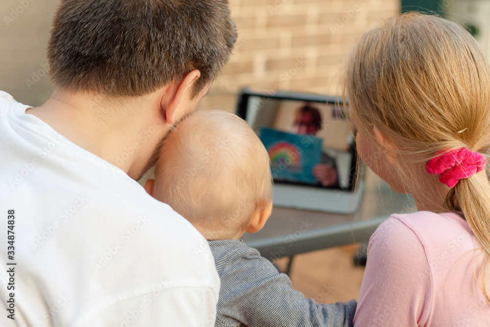 Family video chat - a man with two children using tablet for communication Family video chat - a man with two children using tablet for communication