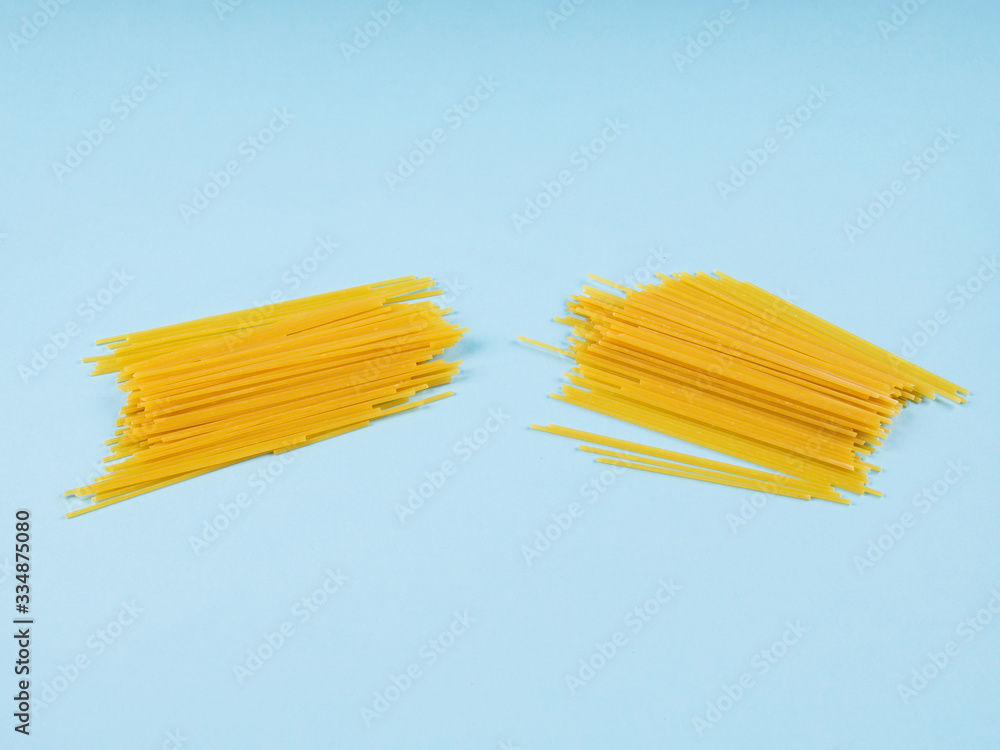 Concept of economic crisis in Italy due to Covid-19 pandemic with broken in half spaghetti on blue abstract background