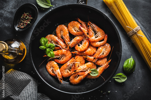 Fried shrimps with spices on pan