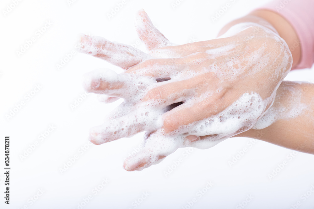 Closeup woman washing hands with soap on white background. Healthcare and disinfection concept. Closeup woman washing hands with soap on white background. Healthcare and disinfection concept.